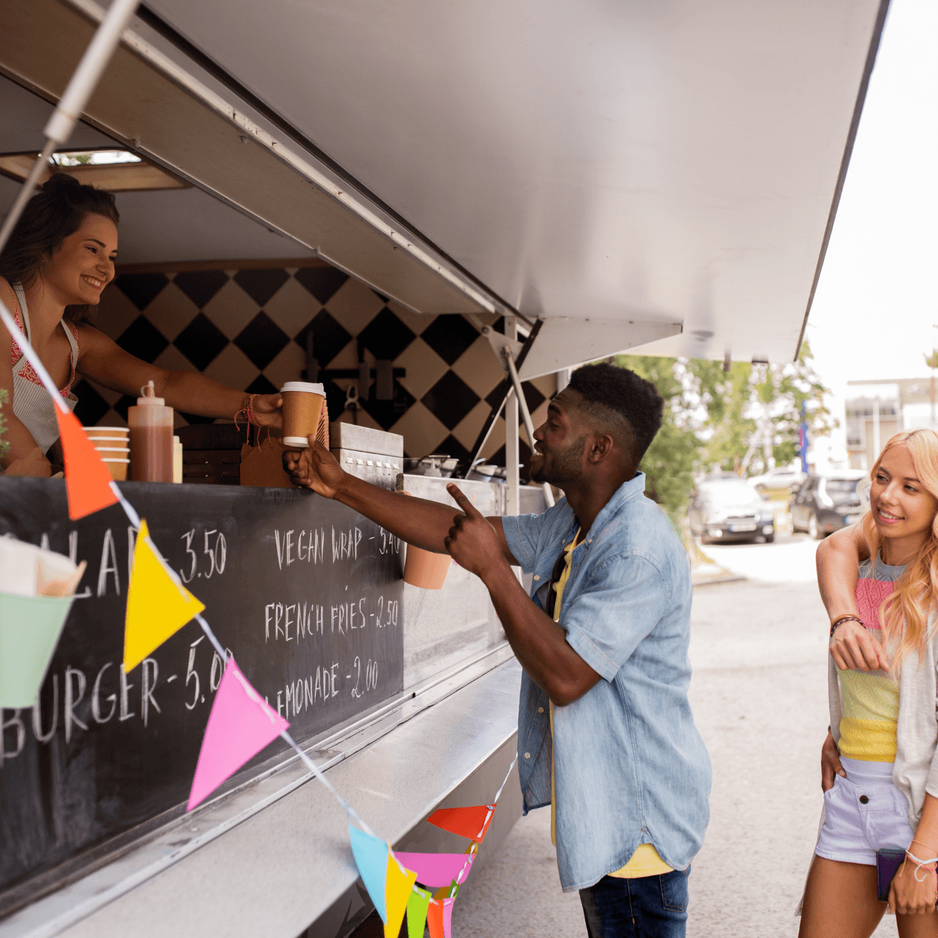 A food truck owner serving customers
